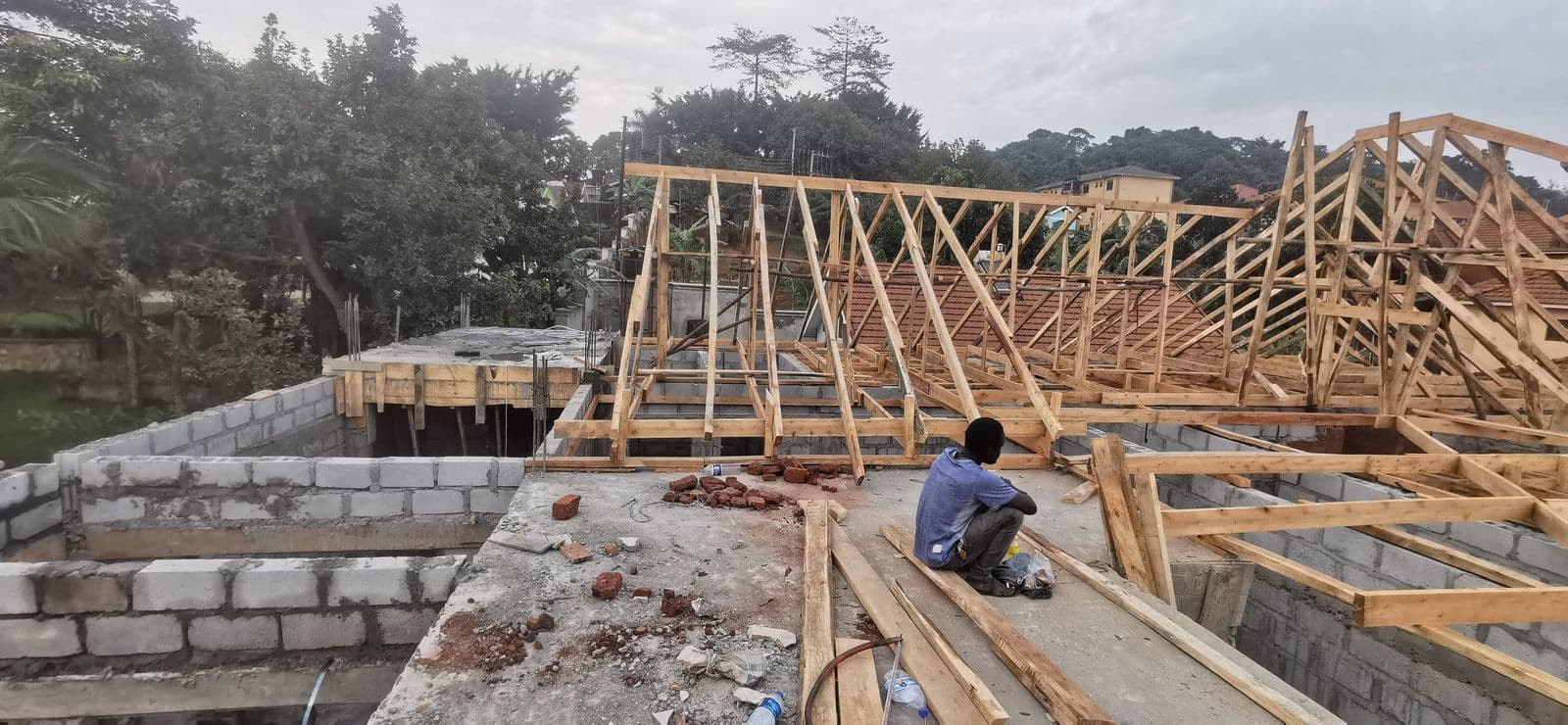 Timber roof truss installation on a building under construction
