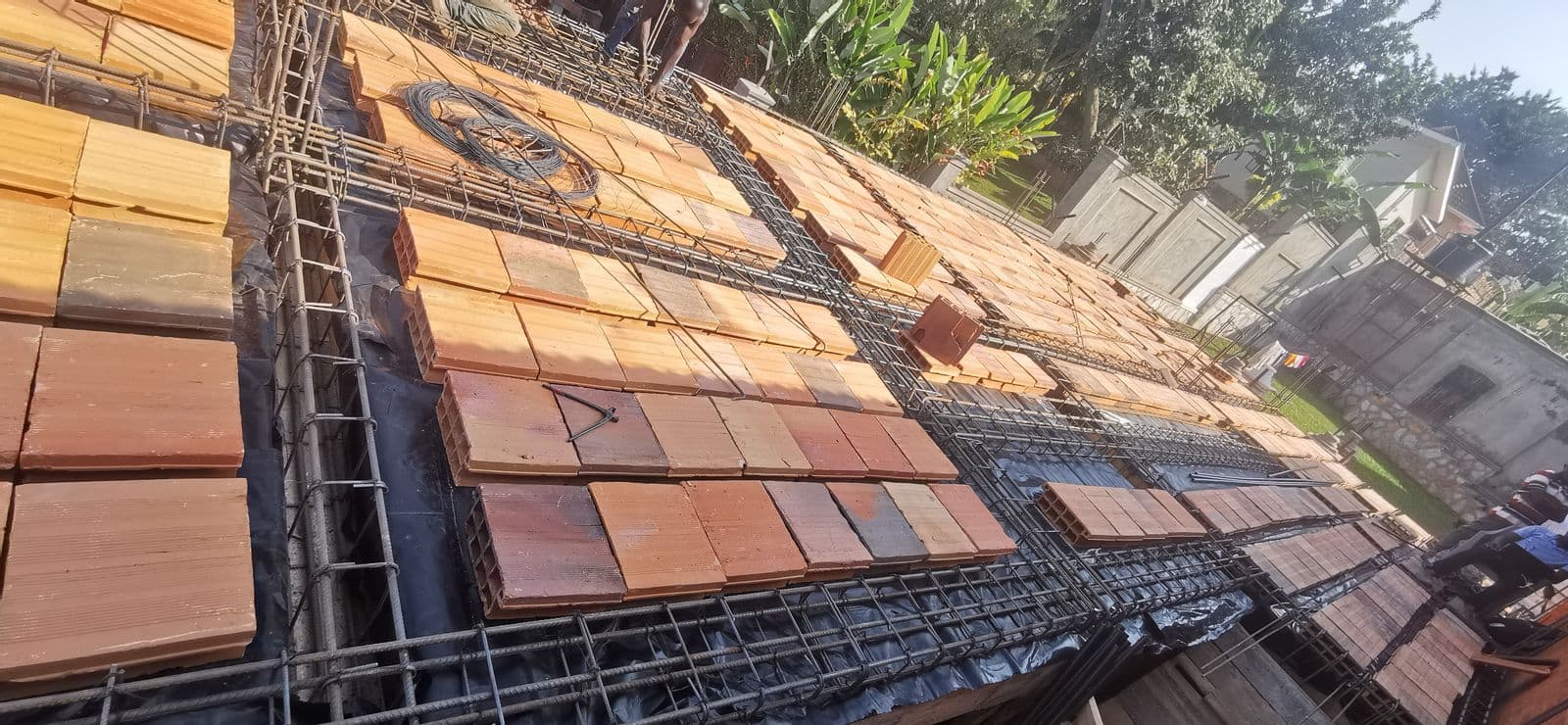 Roofing tiles and reinforcement mesh staged for installation